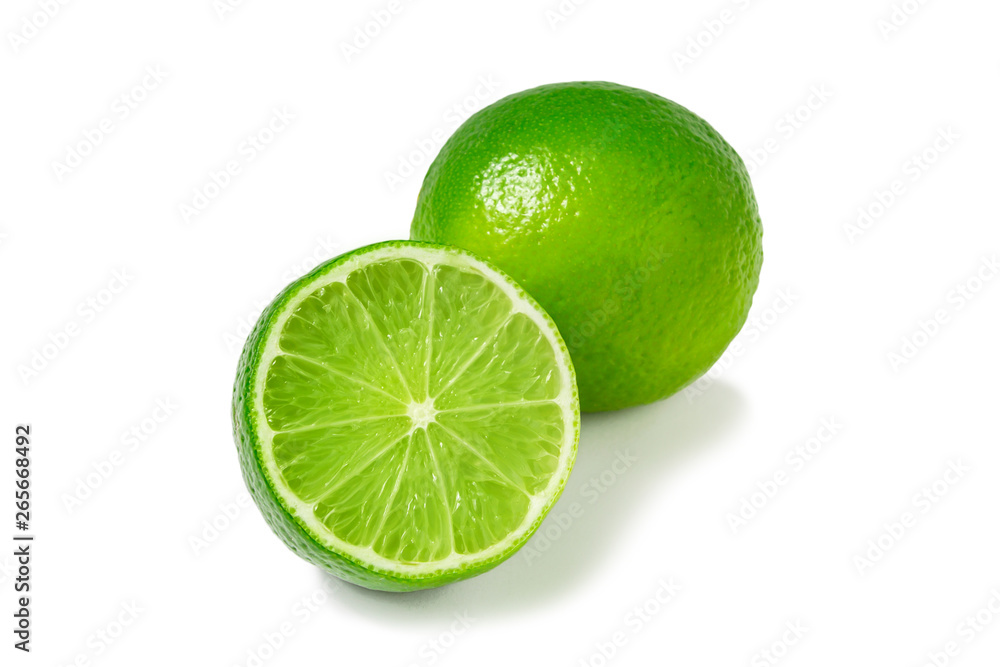 Fresh ripe limes, one whole and one half isolated on white background with shadow - image Fresh ripe limes, one whole and one half isolated on white background with shadow - image