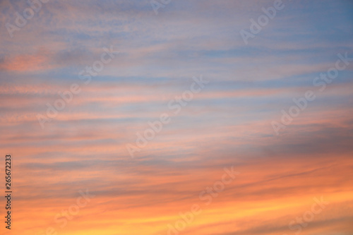 Dramatic sunset sky background with fiery clouds, yellow, orange and pink colour, nature background. Beautiful skies © Atlas