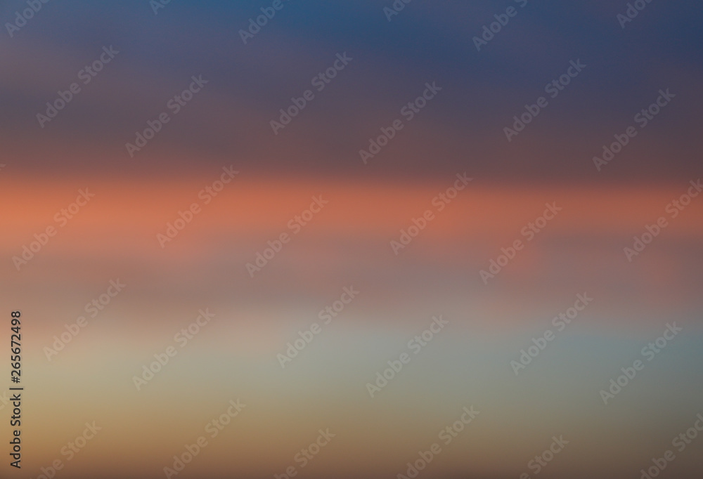 Dramatic sunset sky background with fiery clouds, yellow, orange and pink colour, nature background. Blurred background
