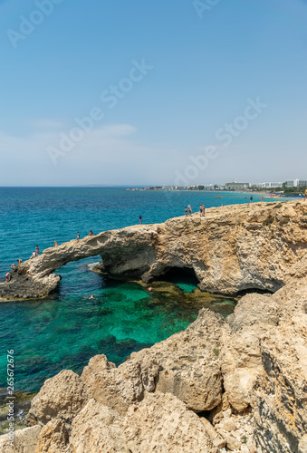 CYPRUS, THE BRIDGE OF LOVERS - MAY 11/2018: Tourists jump from a height into the azure waters of the Mediterranean Sea.