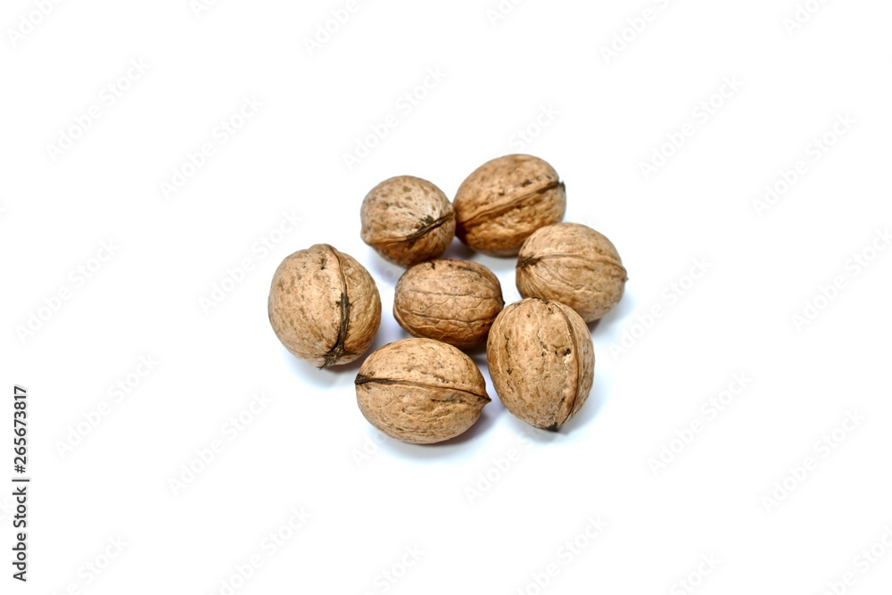 Inshell walnuts. Quantity - seven pieces. Centered on a white background. Close-up. Inshell walnuts. Quantity - seven pieces. Centered on a white background. Close-up.