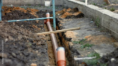 Wallpaper Mural Sewerage pipeline construction. Laying new sewerage pipe into the ground. Motion up Torontodigital.ca