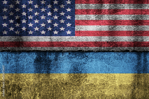 two flags on a cracked wall, USA and Ukraine