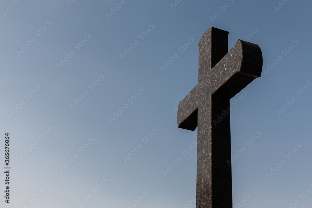 granite cross against the blue sky