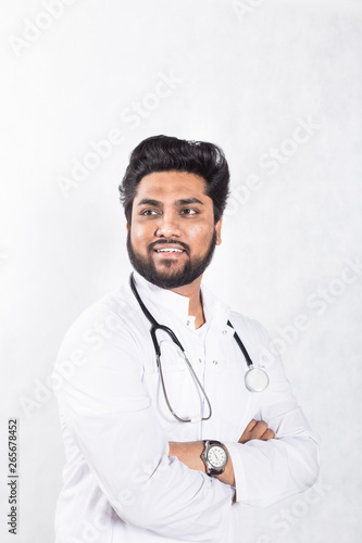 Handsome young doctor in a white coat with a stethoscope. Health care concept.