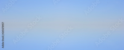 Blue sky gradient background with small clouds texture. Blank backdrop of pale light blue tone, sky banner with copy space
