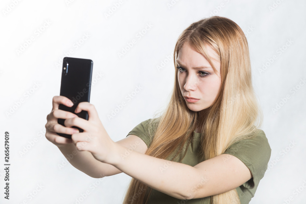 Beautiful young woman taking pictures on a smartphone. Beautiful young woman taking pictures on a smartphone.