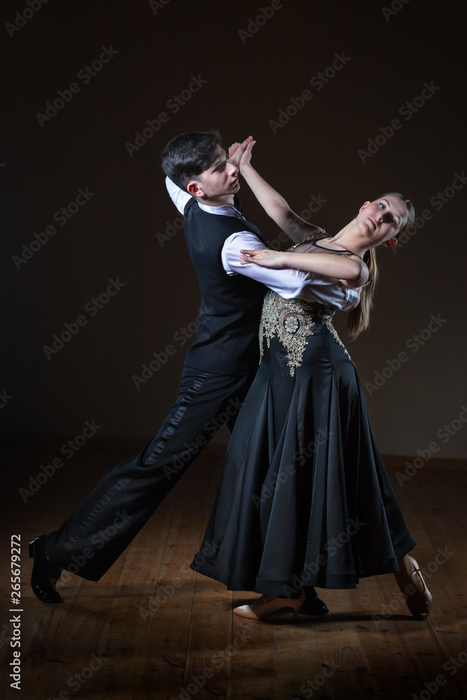 Beautiful young dancers in ballroom isolated on black background Beautiful young dancers in ballroom isolated on black background