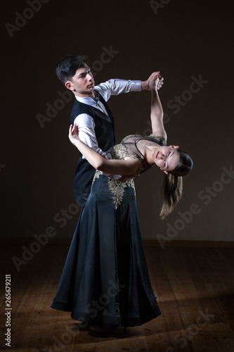 Beautiful young dancers in ballroom isolated on black background