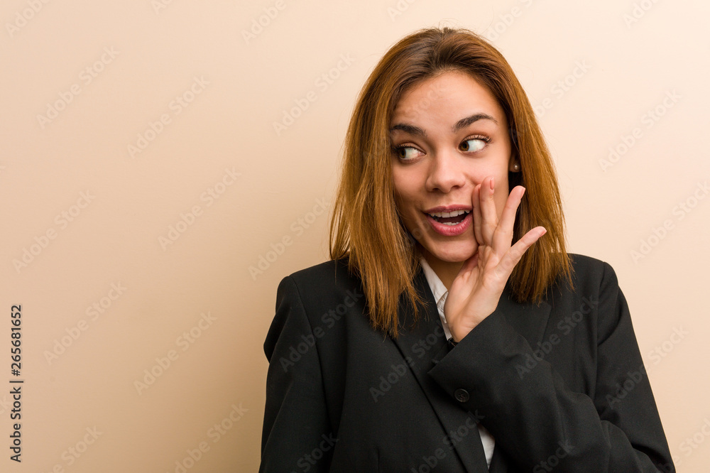 Young caucasian business woman is saying a secret hot braking news and looking aside Young caucasian business woman is saying a secret hot braking news and looking aside