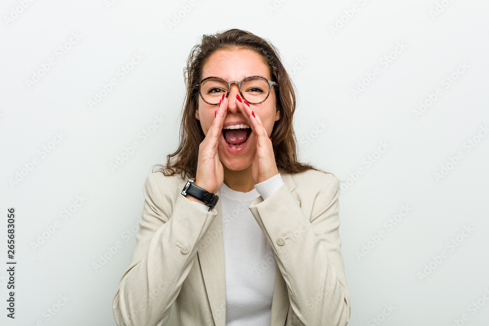 Young european business woman shouting excited to front. Young european business woman shouting excited to front.