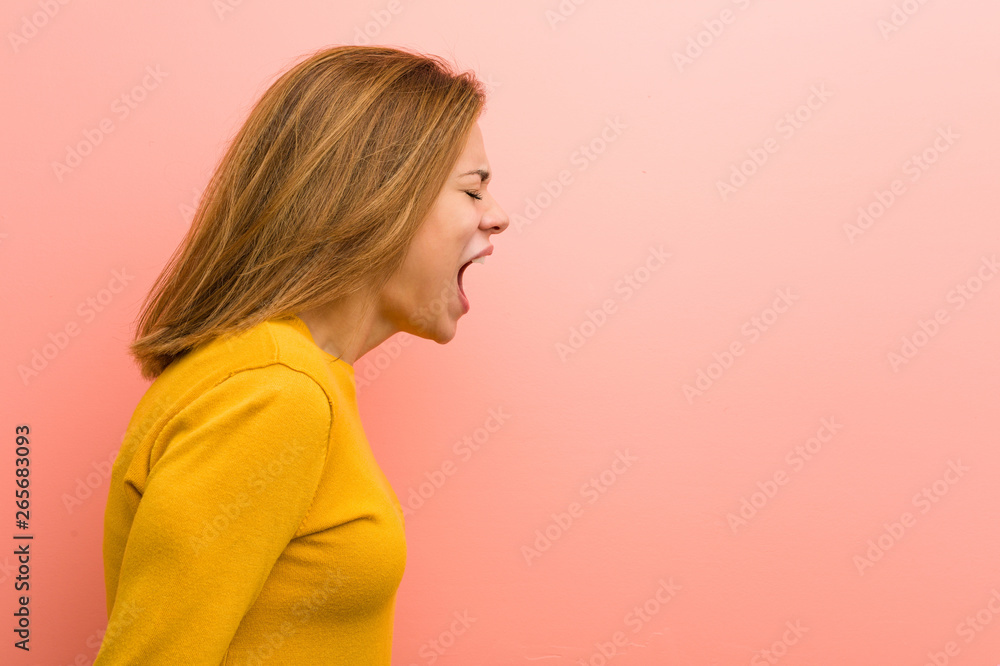 Young pretty young woman shouting towards a copy space Young pretty young woman shouting towards a copy space