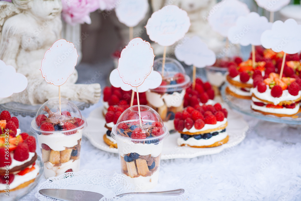 Buffet with sweets. Cakes with raspberries. Sweet table for banquets, weddings, parties.
