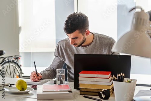 Papier peint Young man, college student studying for an exam