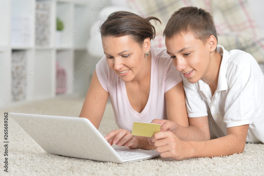 Close-up portrait of mother and son using laptop, online shopping concept Close-up portrait of mother and son using laptop, online shopping concept
