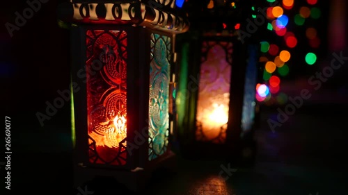 Low light studio set up shot of lighted lantern - showing ramadan kareem or eid mubarak celebration conceptual. photo