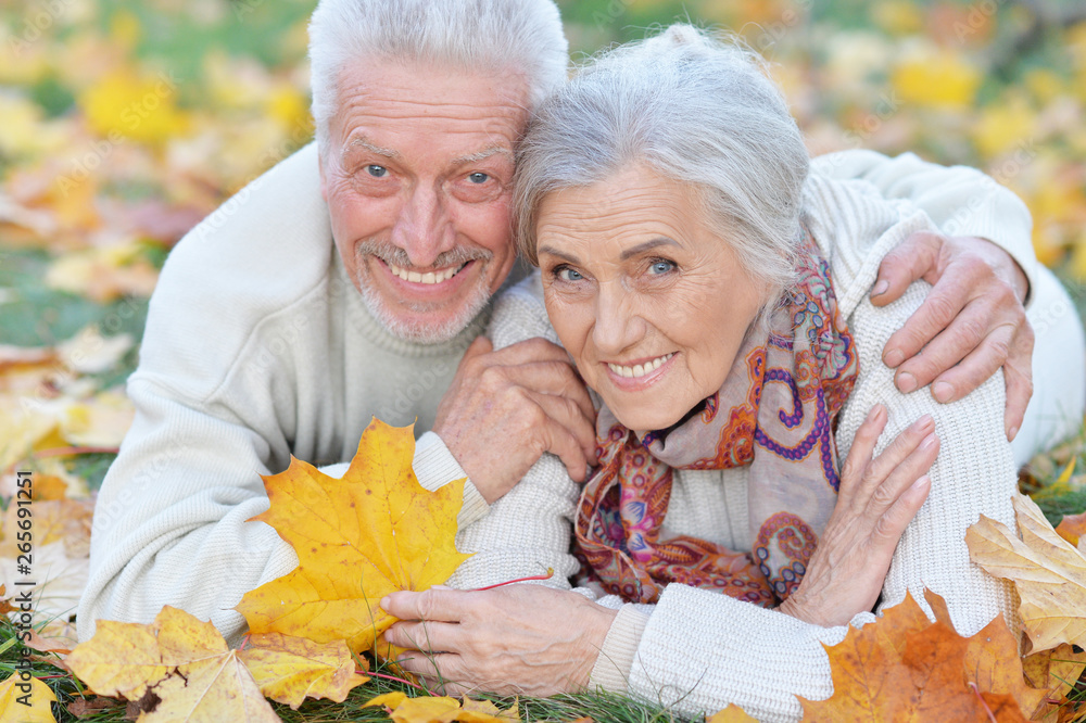 Close-up portrait of happy senior couple lying in park Close-up portrait of happy senior couple lying in park