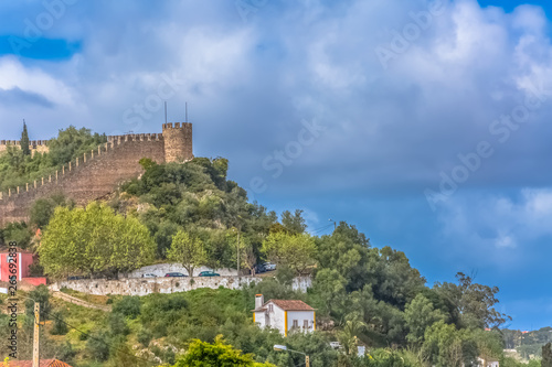 View of the fortress and Luso Roman castle of   bidos  with buildings of Portuguese vernacular architecture and sky with clouds  in Portugal