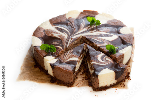 Vanilla and chocolate cheesecake decorated with dark chocolate isolated on white