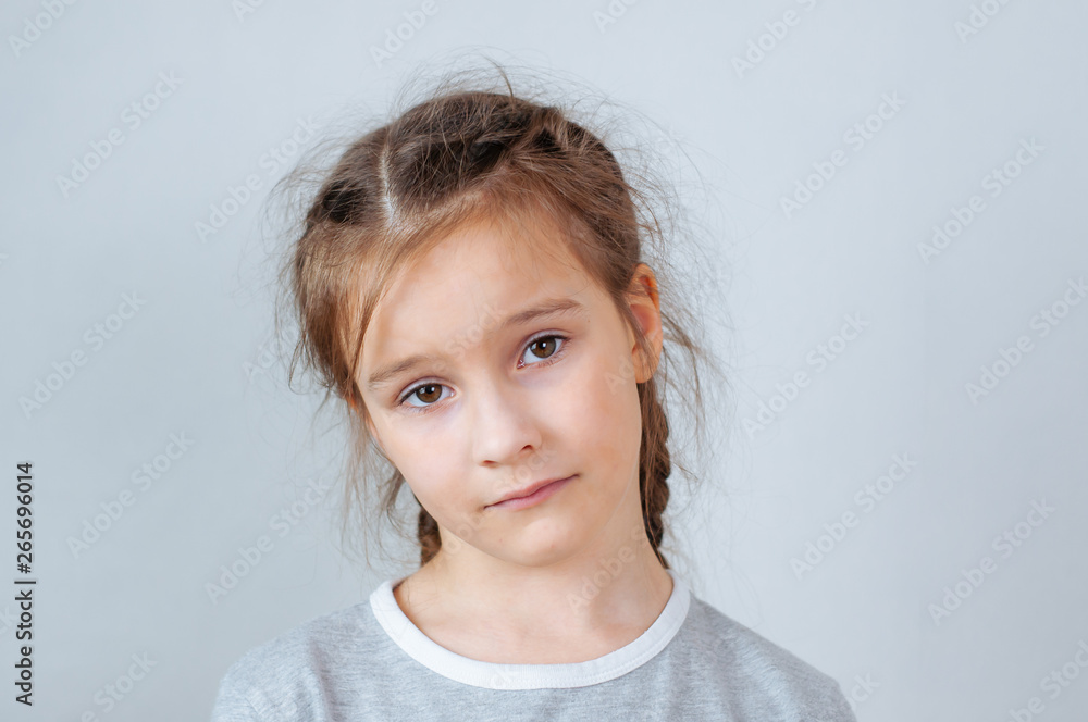 Studio emotional portrait of a serious little girl with long hair Studio emotional portrait of a serious little girl with long hair