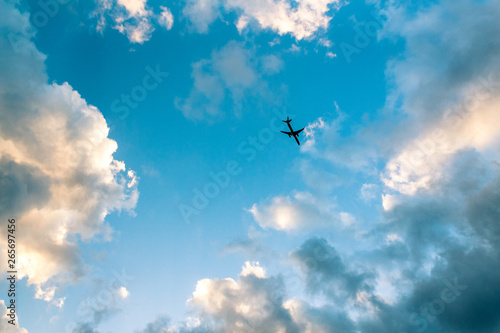 airplane view from the ground looking up clear sky and clouds as background