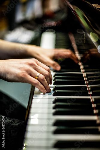 hands playing the piano at a concert