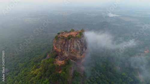 Lion Rock Ancient Fortress of Sigiriya, Aerial reveal as mist flows in early morning photo