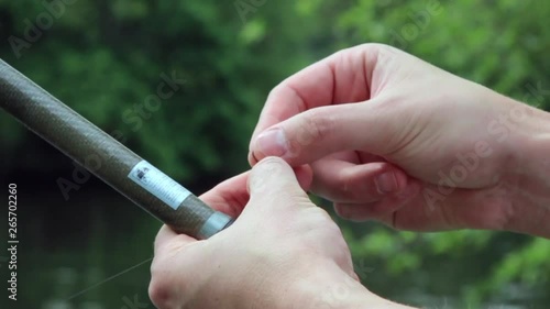 fisherman preparing bait for fish on the hook