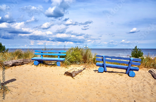 Fototapeta Naklejka Na Ścianę i Meble -  Two blue benches on the cliff in Ückeritz on the beach. Baltic Sea in Mecklenburg-Vorpommern, Germany.