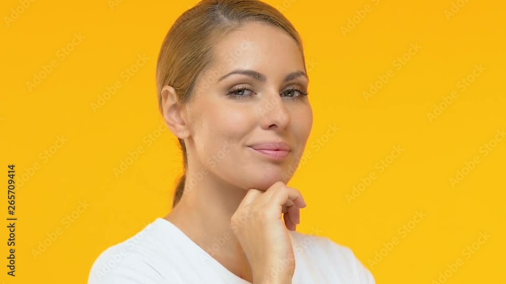 Attractive lady stroking face, perfect moisturized skin, cosmetological service