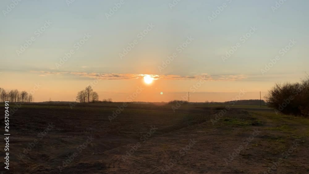 Sun setting over a latvian meadow in time lapse Sun setting over a latvian meadow in time lapse