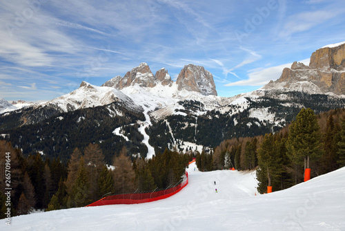 Skiers going down the slope at Val Di Fassa in Italy