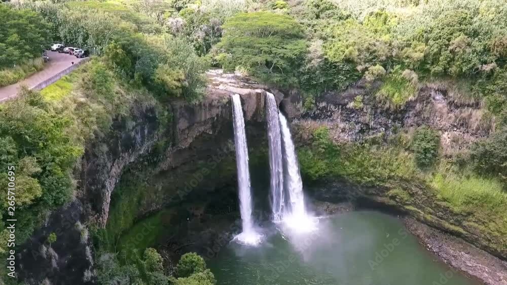 Drone Aerial Flying To Waimea Waterfalls on Kauai Island Hawaii USA With Clear River Water and Tropical Vegetation Drone Aerial Flying To Waimea Waterfalls on Kauai Island Hawaii USA With Clear River Water and Tropical Vegetation