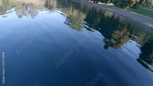 Fast Low Flying Over Calm Lake Surface, Racing Drone. photo