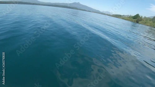 Low Aerial FPV Speeding Over Water Surface. photo