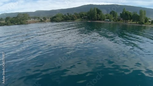 Racing Drone Flying Fast Over Lake Surface photo