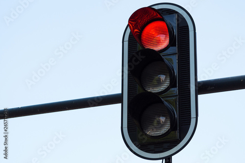 Red traffic light on white background