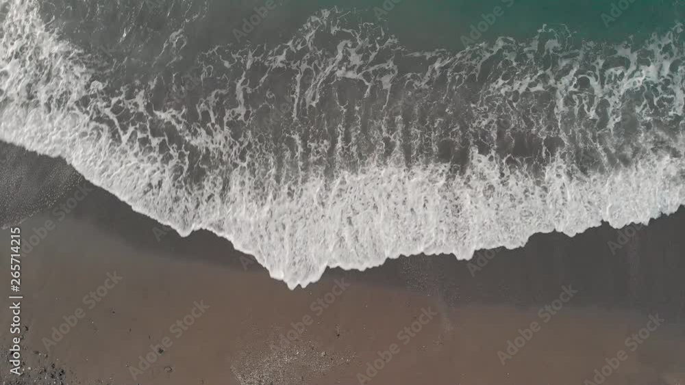 Morning winter light. Playa de Maro, near Nerja. An aerial with clockwise rotation looking down at turquoise sea, waves lapping onto the beach with sand and pebbles. Andulasia, Iberia, Southern Spain. Morning winter light. Playa de Maro, near Nerja. An aerial with clockwise rotation looking down at turquoise sea, waves lapping onto the beach with sand and pebbles. Andulasia, Iberia, Southern Spain.