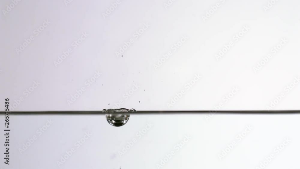 In studio shot of water splashing on the water surface at 1000 fps In studio shot of water splashing on the water surface at 1000 fps
