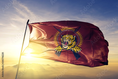 Tamil Eelam flag waving on the top sunrise mist fog