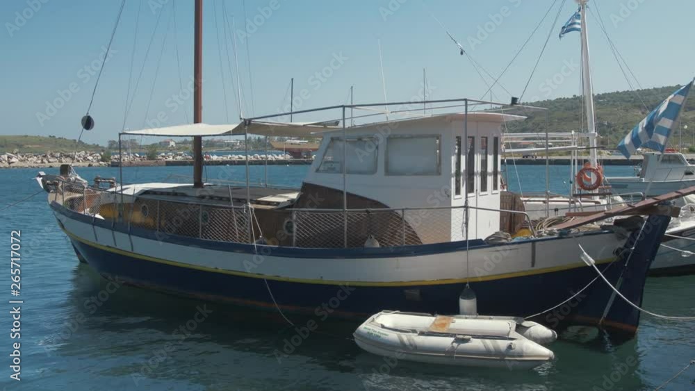 Lovely wooden carvel built sail boat moored at quite Greek village harbor CLOSE UP Lovely wooden carvel built sail boat moored at quite Greek village harbor CLOSE UP