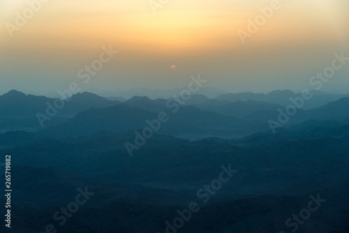 View of the sunrise on the bare mountain from the top of the mountain