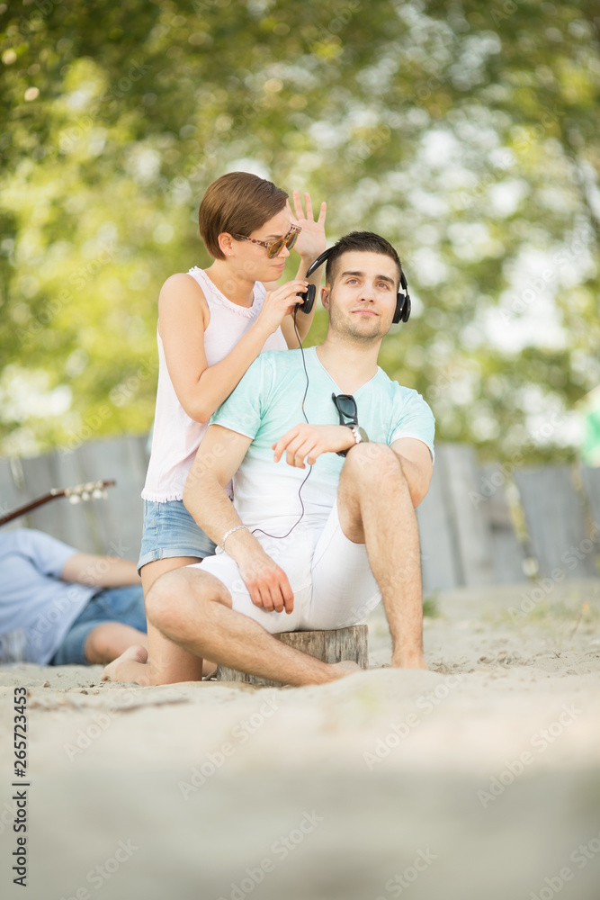 Fototapeta premium Young beautiful couple at the beach