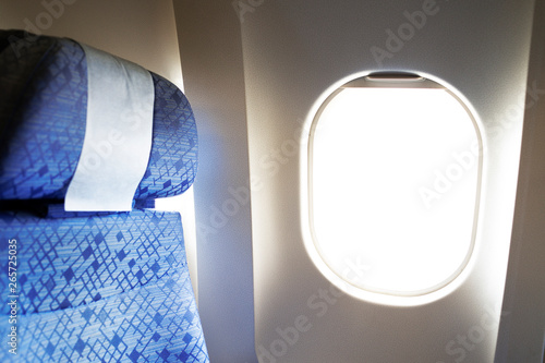 Comfortable aircraft seats with headrest by the window.