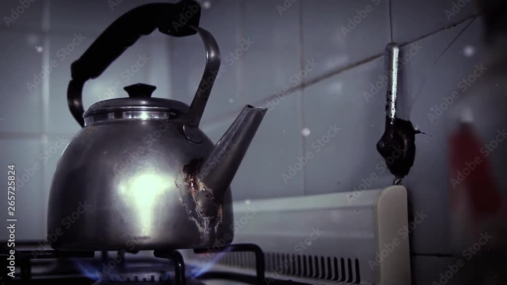 Oldfashioned Silver Kettle with Spout and Handle Boiling Water on a