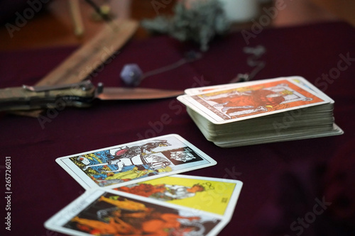 Tarot cards, amulets and ritual knife. Occult, esoteric, divination and wicca concept. Mystic and vintage background.