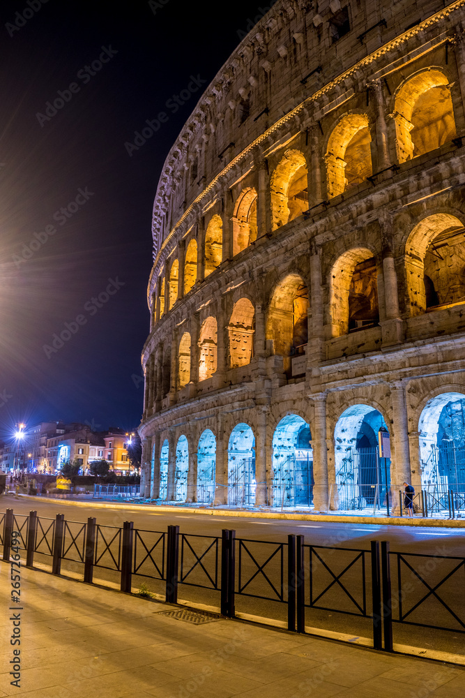 The side of the Great Roman Colosseum photographed on the street at night - Rome Italy