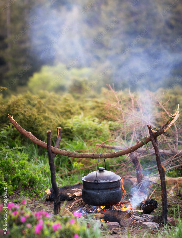 Kettle on fire in the forest during hike or trekking in nature. Kettle on fire in the forest during hike or trekking in nature.