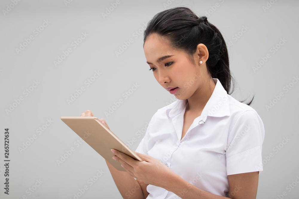 Young Asian University Student Woman in White Uniform cover face with hygiene mask protect from poor environment pm 2.5 industrial dust health, portrait half body studio lighting gray background Young Asian University Student Woman in White Uniform cover face with hygiene mask protect from poor environment pm 2.5 industrial dust health, portrait half body studio lighting gray background