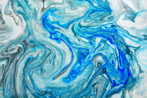 Abstract beautiful blue marble pattern with black color.The Eastern style of Ebru painting on water with acrylic paints swirls.A stylish mix of colors natural luxury.